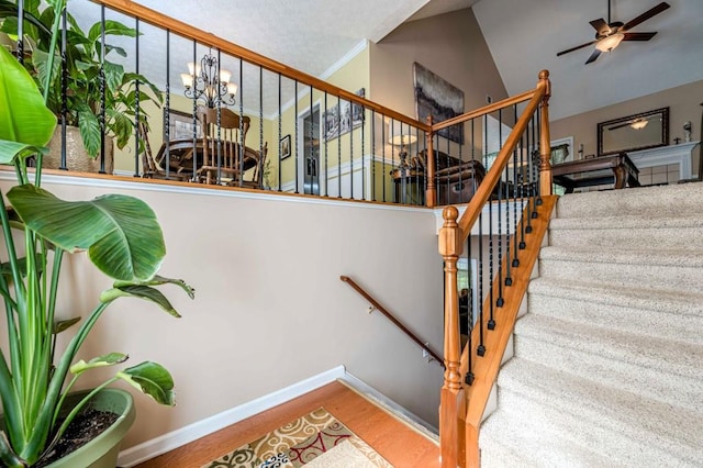 435 Flowering Trl, Grayson, GA 30017 - stairs featuring wood finished floors, baseboards, ceiling fan, high vaulted ceiling, and a chandelier