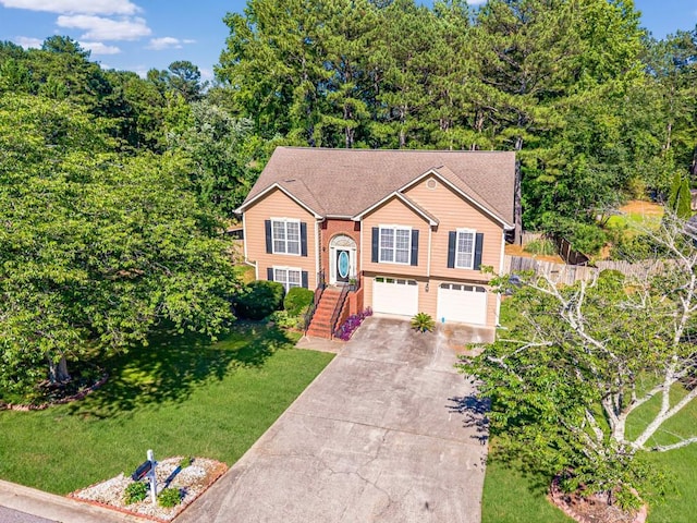435 Flowering Trl, Grayson, GA 30017 - raised ranch featuring concrete driveway, a garage, and a front yard