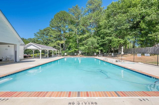 435 Flowering Trl, Grayson, GA 30017 - community pool featuring a gazebo, view of wooded area, and a patio area