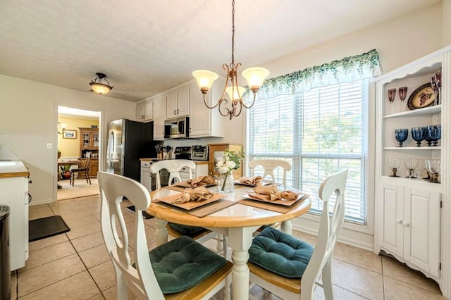 435 Flowering Trl, Grayson, GA 30017 - dining area with light tile patterned flooring and a chandelier