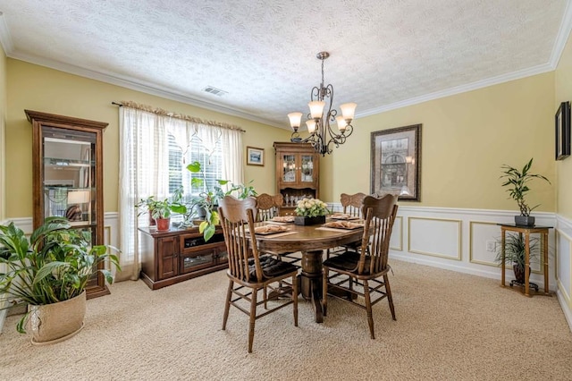 435 Flowering Trl, Grayson, GA 30017 - dining space featuring a chandelier, light carpet, crown molding, a wainscoted wall, and a textured ceiling