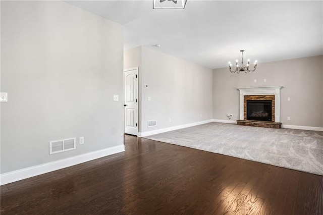 399 Cobblestone Trl, Dallas, GA 30132 - unfurnished living room with a chandelier, visible vents, baseboards, and wood finished floors
