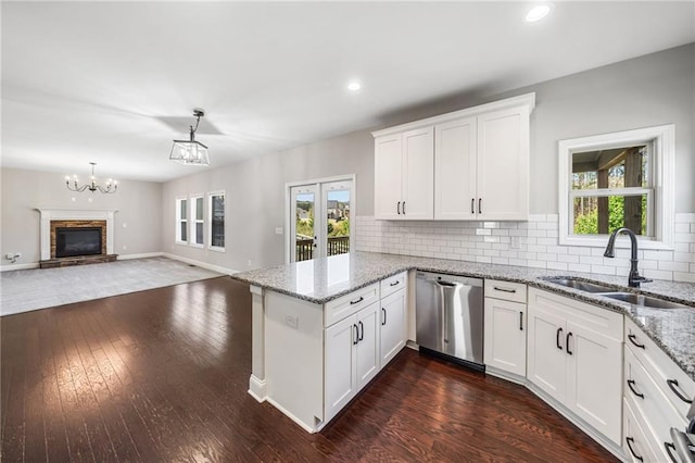 399 Cobblestone Trl, Dallas, GA 30132 - kitchen featuring a sink, a peninsula, dark wood-style floors, white cabinetry, and stainless steel dishwasher
