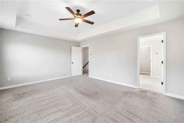 399 Cobblestone Trl, Dallas, GA 30132 - carpeted empty room with ceiling fan, baseboards, and a raised ceiling