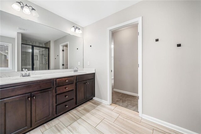 399 Cobblestone Trl, Dallas, GA 30132 - full bathroom featuring a shower stall, visible vents, a sink, double vanity, and baseboards