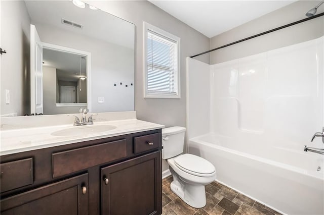 399 Cobblestone Trl, Dallas, GA 30132 - bathroom with stone finish floor, vanity, visible vents, toilet, and washtub / shower combination