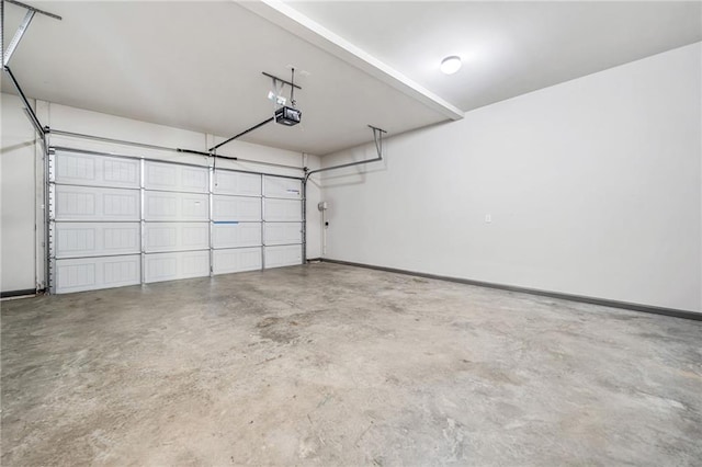 399 Cobblestone Trl, Dallas, GA 30132 - garage featuring baseboards and a garage door opener