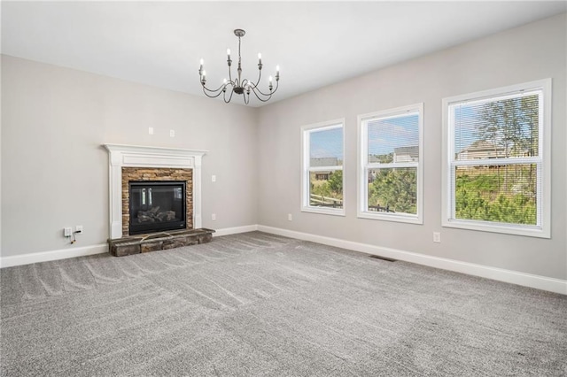 399 Cobblestone Trl, Dallas, GA 30132 - unfurnished living room with visible vents, baseboards, an inviting chandelier, a fireplace, and carpet floors