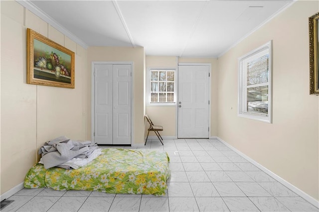 foyer entrance featuring visible vents, crown molding, and baseboards