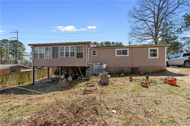 back of property featuring fence