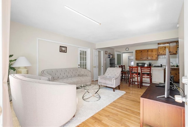 living area featuring light wood-style flooring