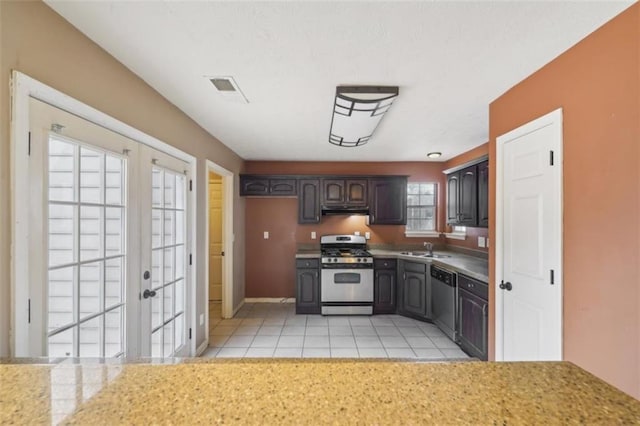 kitchen featuring french doors, sink, dark brown cabinets, light tile patterned floors, and stainless steel appliances