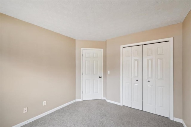 unfurnished bedroom featuring carpet floors and a closet