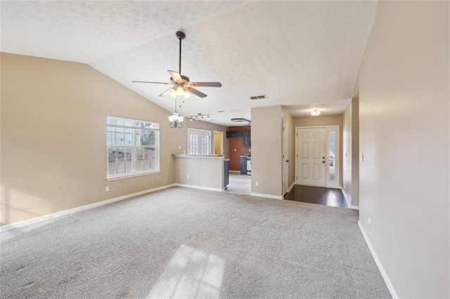 unfurnished living room with lofted ceiling, ceiling fan, and carpet