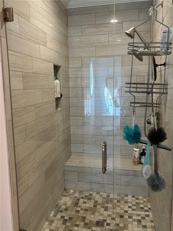 bathroom featuring a shower with door