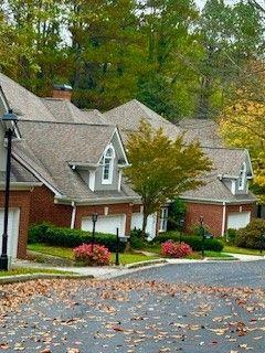 front of property with a garage and a front lawn