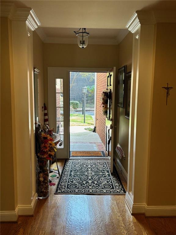 living room featuring ornamental molding, hardwood / wood-style flooring, and a healthy amount of sunlight