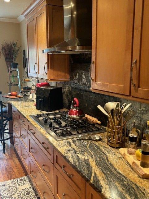 bar with light stone countertops, wine cooler, and light hardwood / wood-style flooring