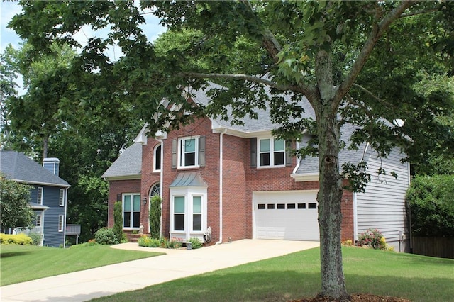 view of front of property with concrete driveway, a garage, brick siding, and a front yard