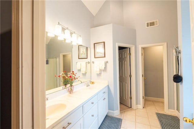 full bath featuring tile patterned flooring, a shower with door, high vaulted ceiling, double vanity, and baseboards