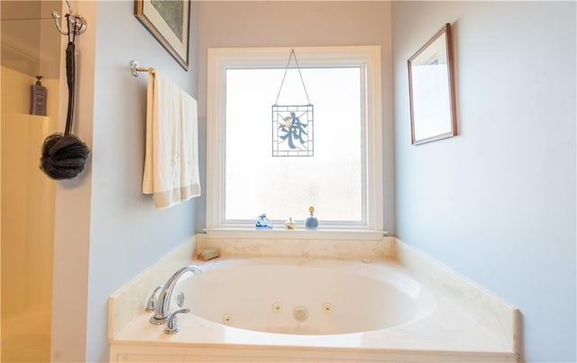 full bathroom with a tub with jets