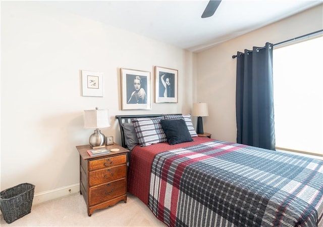 carpeted bedroom featuring baseboards and ceiling fan