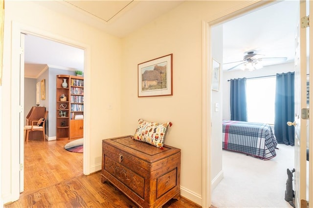 hallway featuring wood finished floors and baseboards