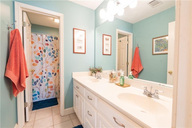 bathroom with tile patterned floors and double vanity