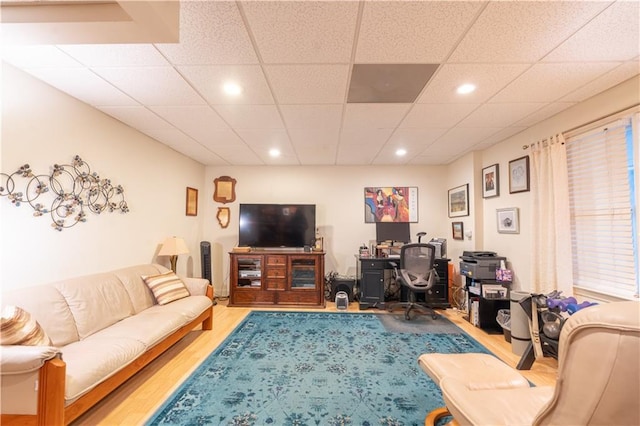 living area featuring wood finished floors, a desk, recessed lighting, and a drop ceiling