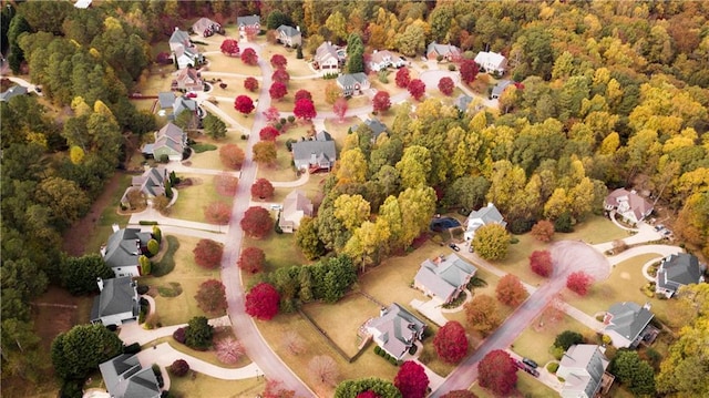 aerial view of residential area featuring a heavily wooded area