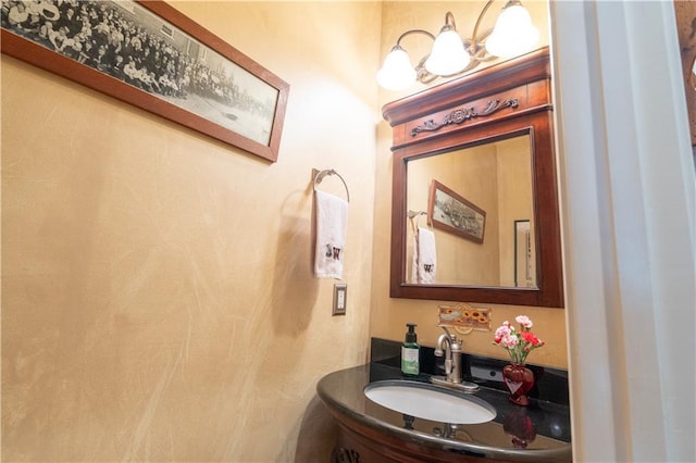 bathroom featuring a sink and a chandelier