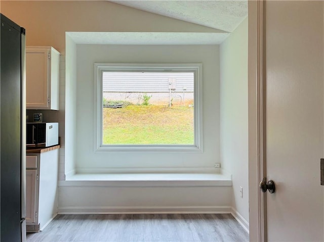 225 Magnolia Tree Ct, Johns Creek, GA 30022 - detailed view of wood finished floors, white microwave, baseboards, and freestanding refrigerator