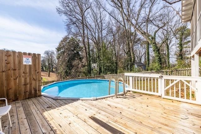 view of pool featuring fence, a fenced in pool, and a wooden deck