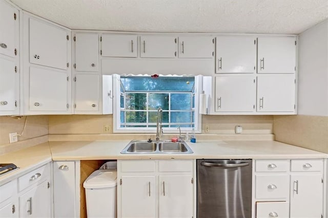 kitchen with white cabinetry, sink, stainless steel dishwasher, and a textured ceiling