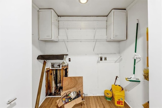 laundry room featuring wood-type flooring