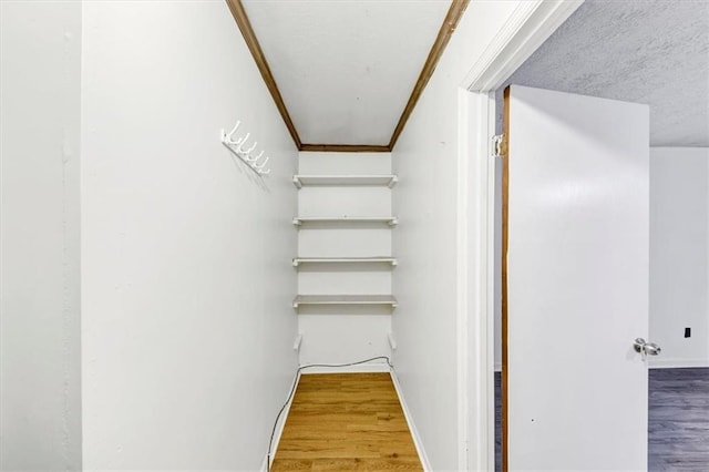 staircase with crown molding and wood-type flooring