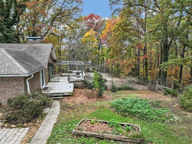 view of yard featuring a pergola and a deck