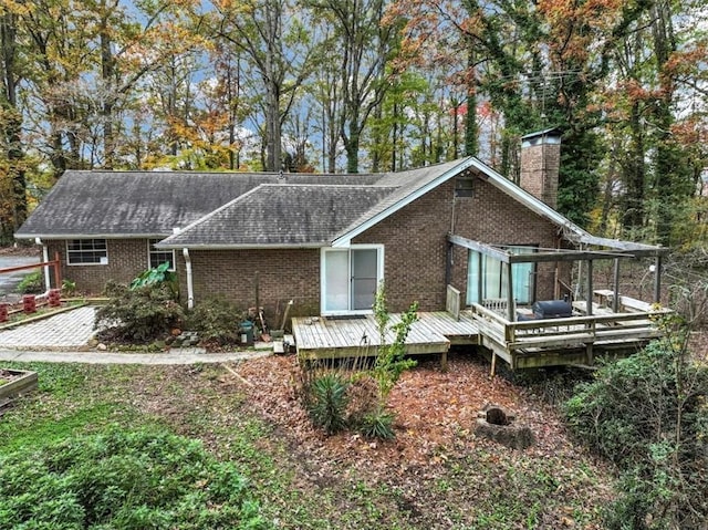 rear view of house with a wooden deck