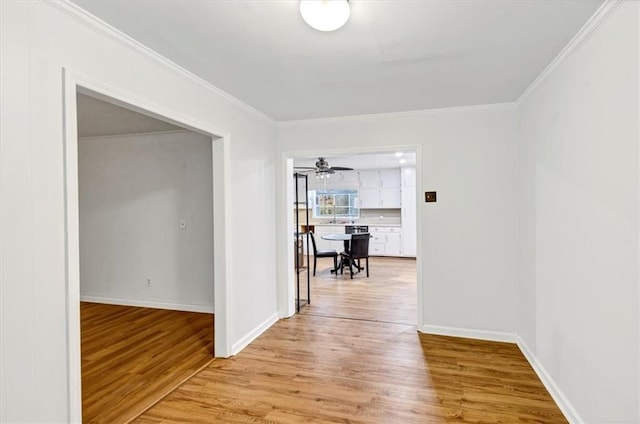 hall featuring crown molding and light wood-type flooring