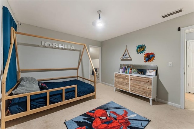 bedroom featuring baseboards, visible vents, and carpet