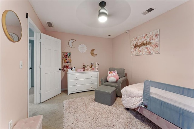carpeted bedroom with visible vents and ceiling fan