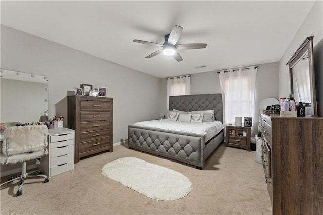 bedroom featuring visible vents, ceiling fan, and light colored carpet