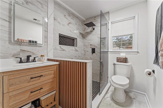 full bathroom with marble finish floor, ornamental molding, toilet, vanity, and a stall shower