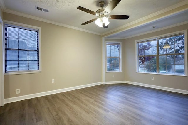 spare room with dark hardwood / wood-style floors, ceiling fan, ornamental molding, and a textured ceiling