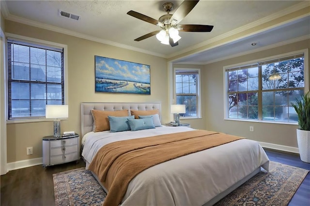 bedroom featuring ceiling fan, dark hardwood / wood-style floors, and ornamental molding