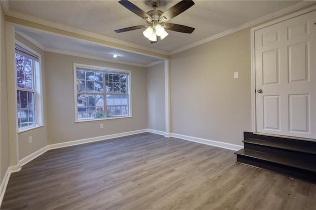 unfurnished room with hardwood / wood-style floors, ceiling fan, and ornamental molding