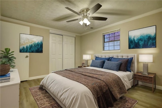 bedroom with a closet, ceiling fan, hardwood / wood-style floors, and ornamental molding