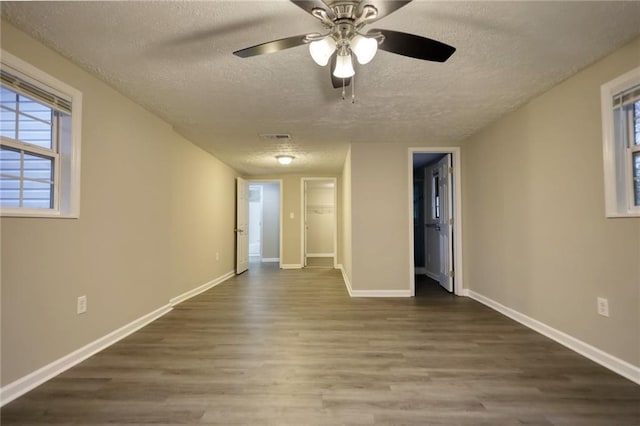 unfurnished room featuring ceiling fan, hardwood / wood-style floors, and a textured ceiling