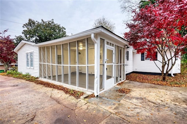 view of side of home featuring a sunroom