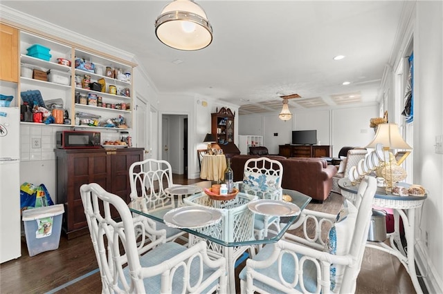 dining space featuring dark wood-type flooring, recessed lighting, and crown molding